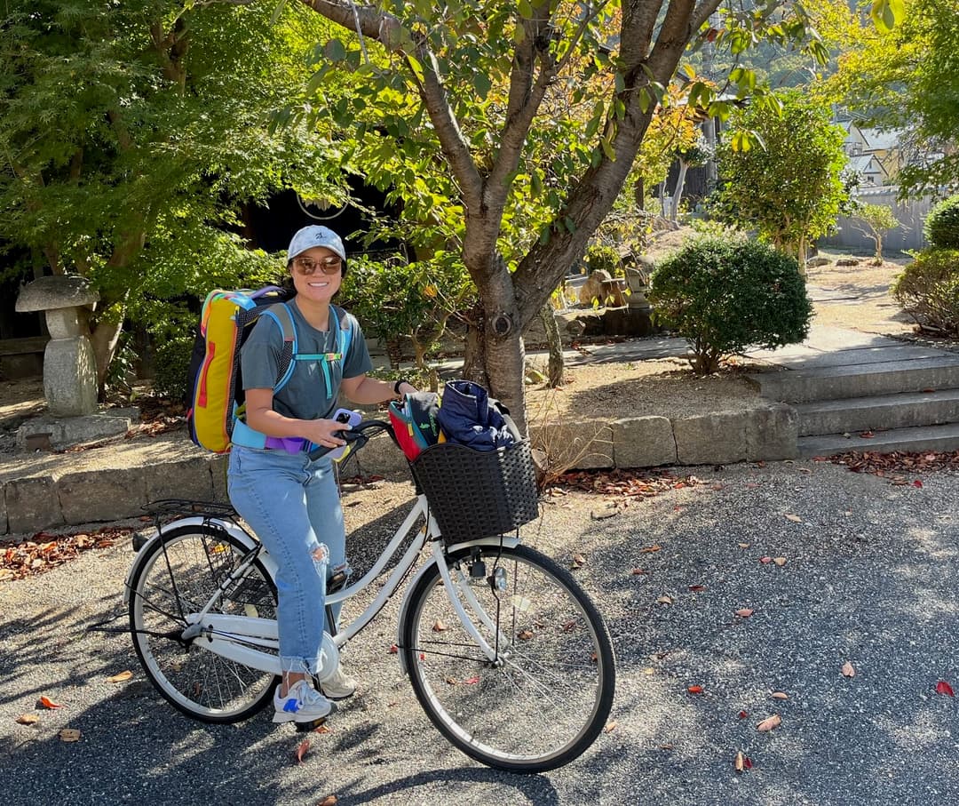 Courtney with luggage on a bike